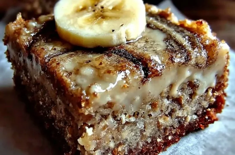 Delicious banana bread brownies served on a plate with a drizzle of chocolate