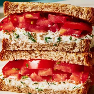Delicious classic tomato sandwich with fresh ingredients on a plate