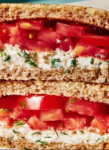 Delicious classic tomato sandwich with fresh ingredients on a plate