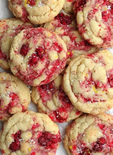 Freshly baked lemon raspberry cookies with a zesty flavor and colorful berries.