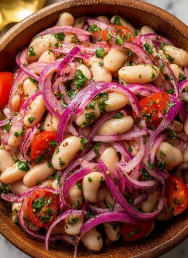 A bowl of Piyaz, traditional Turkish white bean salad with onions and parsley.