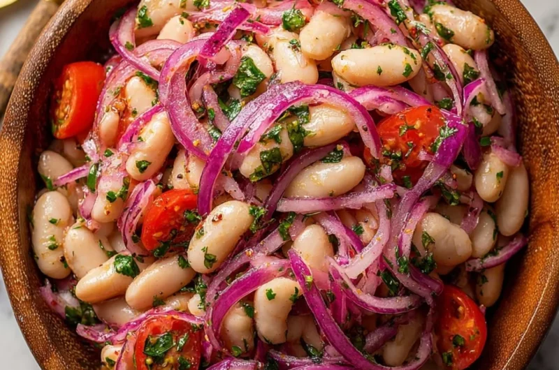 A bowl of Piyaz, traditional Turkish white bean salad with onions and parsley.