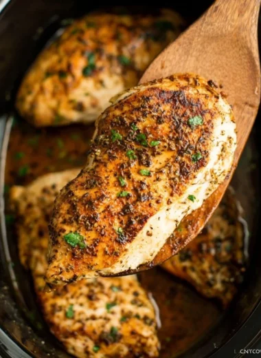Tender slow cooker chicken breasts served with herbs and spices
