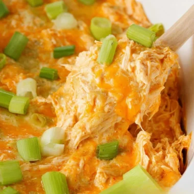 Bowl of spicy buffalo chicken dip served with tortilla chips.