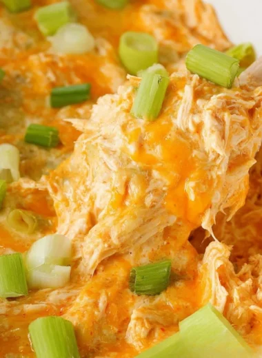 Bowl of spicy buffalo chicken dip served with tortilla chips.