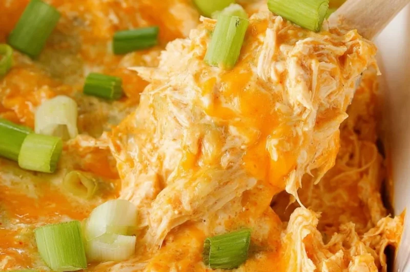 Bowl of spicy buffalo chicken dip served with tortilla chips.