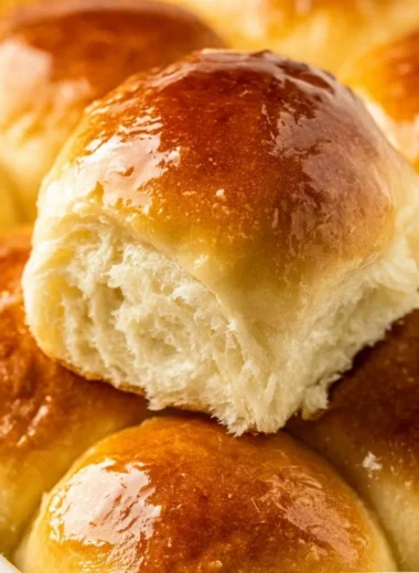 Homemade Sweet Hawaiian bread rolls on a wooden platter