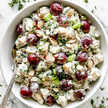 Delicious homemade chicken salad served in a bowl with fresh vegetables.