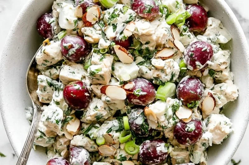 Delicious homemade chicken salad served in a bowl with fresh vegetables.