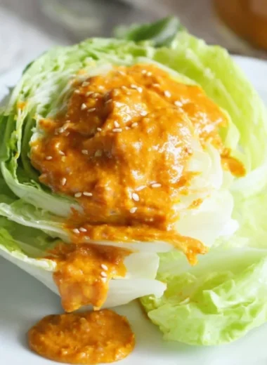 Bowl of homemade Carrot Ginger Dressing with fresh ingredients and vibrant color