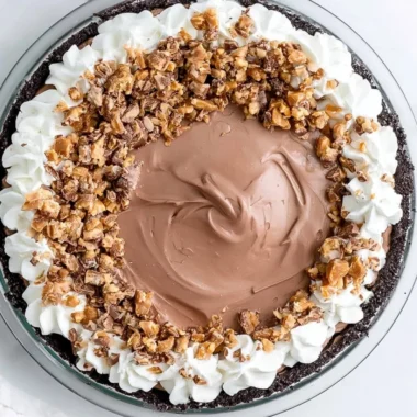 Delicious Chocolate Heath Pie topped with toffee pieces and chocolate ganache