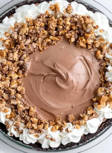 Delicious Chocolate Heath Pie topped with toffee pieces and chocolate ganache