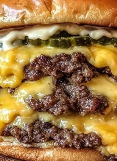 Delicious Crack Burgers stacked with toppings on a wooden table.