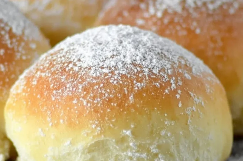 Freshly baked easy potato rolls on a wooden table