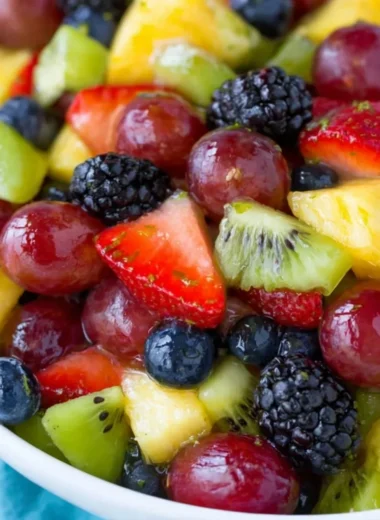 Vibrant fruit salad with honey lime dressing and mixed berries for a refreshing treat.
