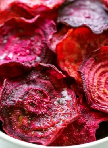 Healthy baked beet chips on a plate, perfect for guilt-free snacking.