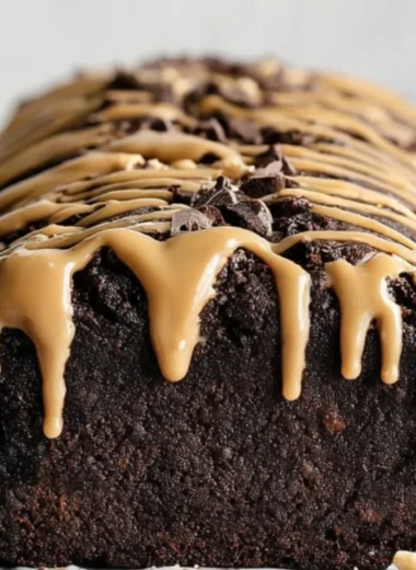 Slice of peanut butter chocolate banana bread on a wooden table