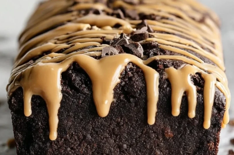 Slice of peanut butter chocolate banana bread on a wooden table