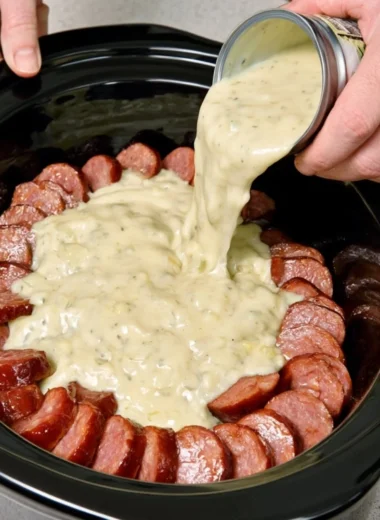 Slow cooker Amish-style sausage noodle bake in a ceramic dish