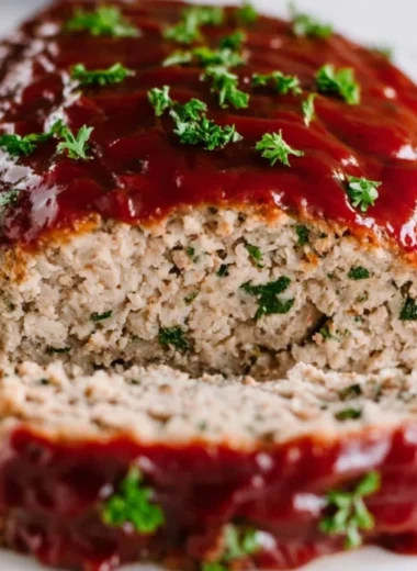 Delicious and juicy Turkey Meatloaf served on a plate with fresh herbs