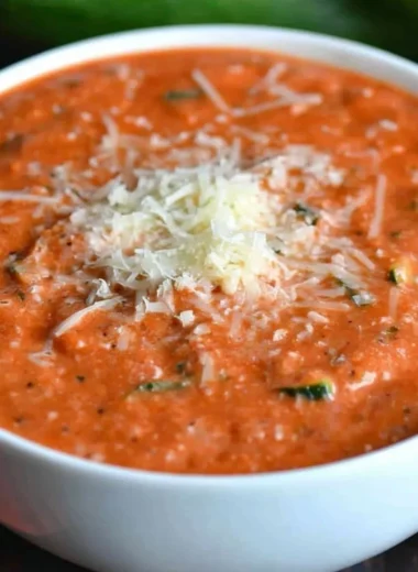 Bowl of delicious zucchini tomato soup garnished with fresh herbs