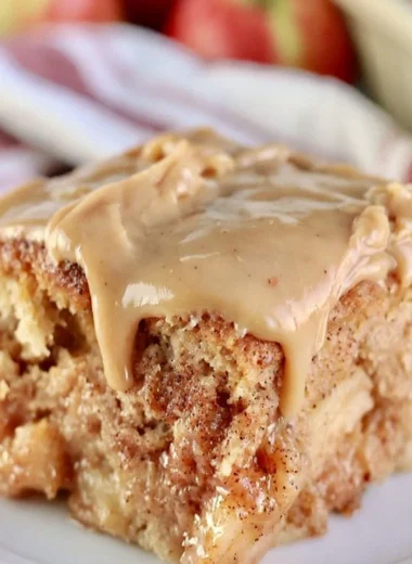 Deliciously moist Apple Dapple Cake with apples and nuts, topped with caramel