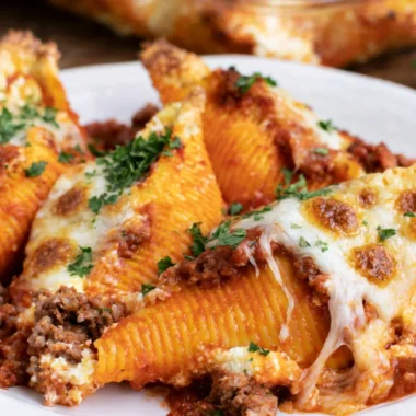 Baked stuffed shells topped with marinara sauce and cheese.