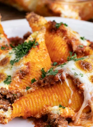 Baked stuffed shells topped with marinara sauce and cheese.