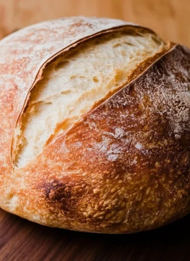 Freshly baked beginners sourdough bread on a wooden table