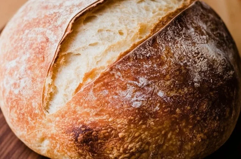 Freshly baked beginners sourdough bread on a wooden table