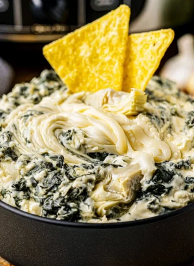 Delicious Crock Pot Spinach Artichoke Dip served with tortilla chips