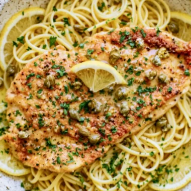 Easy chicken piccata dish with lemon, capers, and parsley garnish.