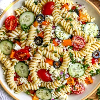Colorful bowl of easy pasta salad with fresh vegetables and dressing