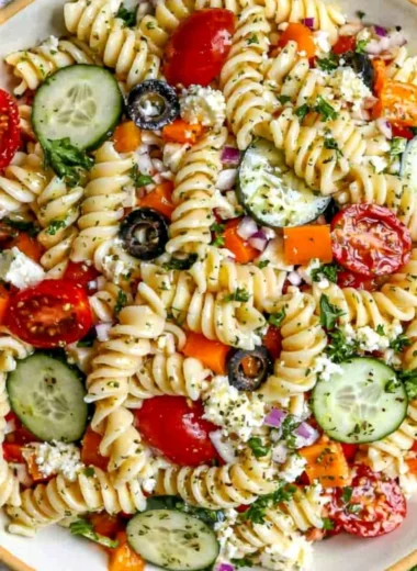 Colorful bowl of easy pasta salad with fresh vegetables and dressing