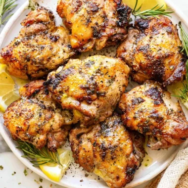 Lemon & Garlic Greek Marinated Chicken served on a plate with fresh herbs