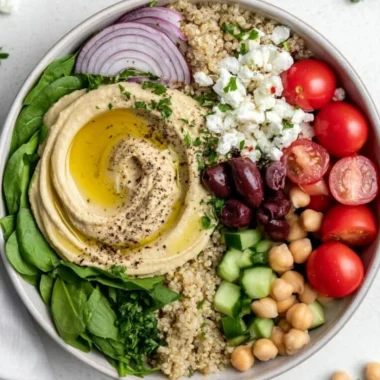 Mediterranean hummus bowl topped with fresh vegetables and spices