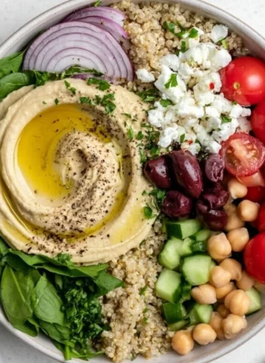 Mediterranean hummus bowl topped with fresh vegetables and spices