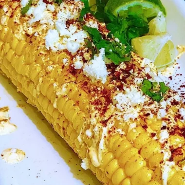 Delicious Mexican Corn Elotes topped with cheese, mayo, and spices