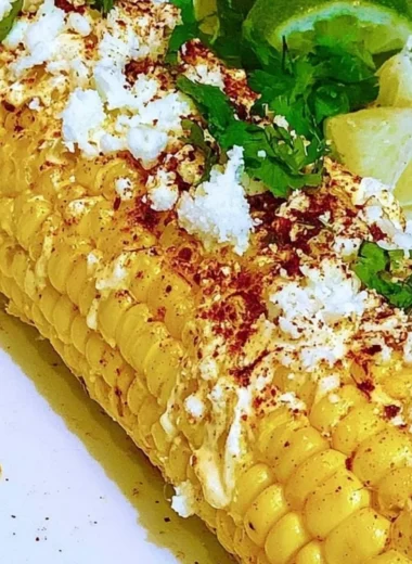 Delicious Mexican Corn Elotes topped with cheese, mayo, and spices