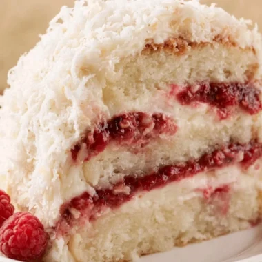 Delicious homemade raspberry layer cake with fresh raspberries and frosting