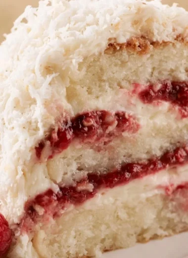 Delicious homemade raspberry layer cake with fresh raspberries and frosting