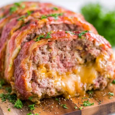 Deliciously smoked meatloaf fresh off the grill, garnished with herbs.