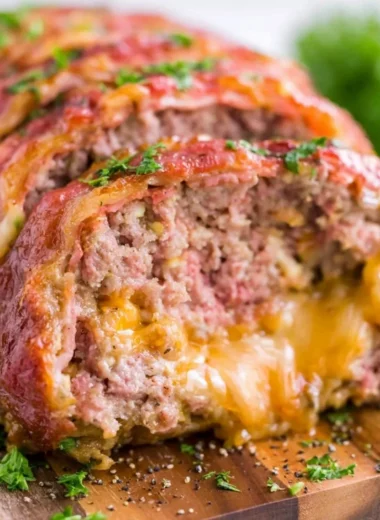 Deliciously smoked meatloaf fresh off the grill, garnished with herbs.