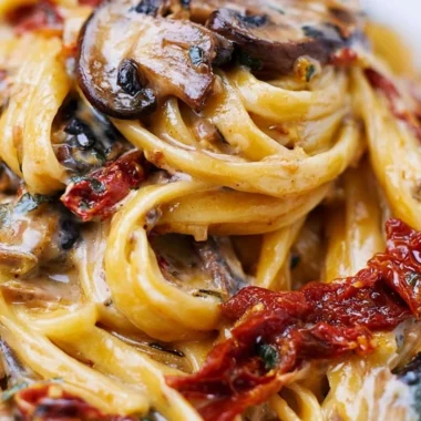 Sun-Dried Tomato Mushroom Pasta served in a bowl topped with herbs