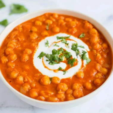Delicious vegan chickpea curry served with rice and fresh herbs