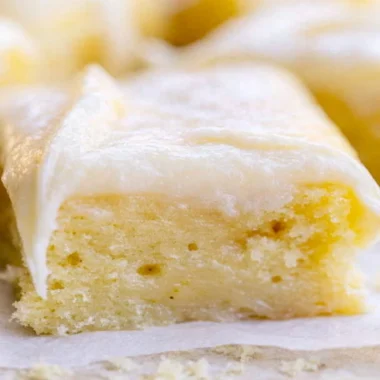 A beautifully frosted White Texas Sheet Cake served on a plate.