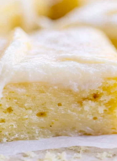 A beautifully frosted White Texas Sheet Cake served on a plate.