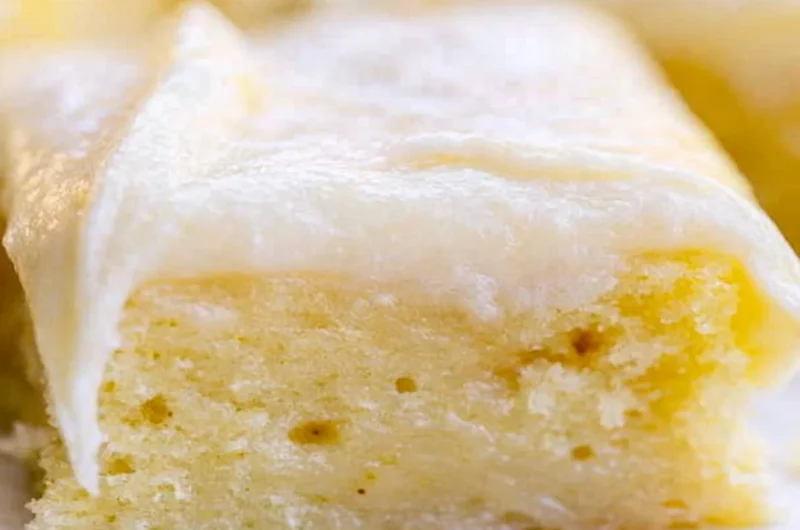 A beautifully frosted White Texas Sheet Cake served on a plate.