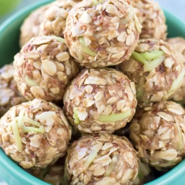 Apple Cinnamon Cookie Energy Bites displayed on a wooden surface.