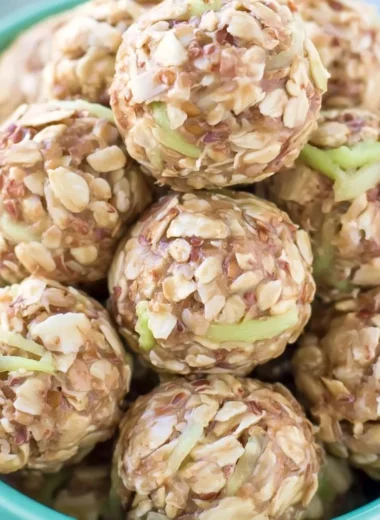 Apple Cinnamon Cookie Energy Bites displayed on a wooden surface.